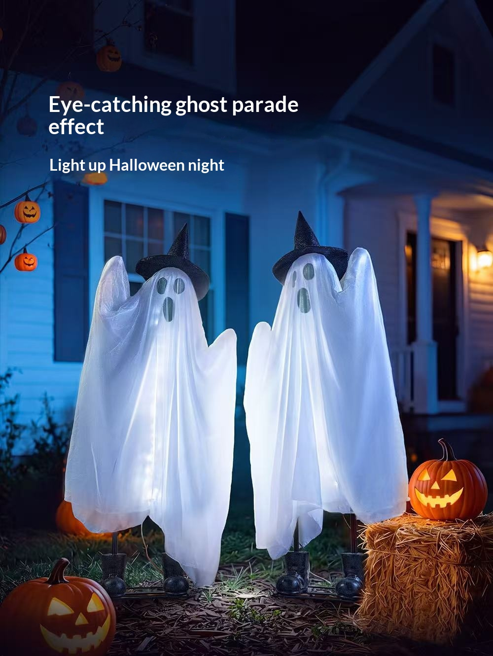 Two glowing white ghost decorations in a Halloween front yard